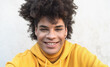 © Alessandro Biascioli - Afro smiling man portrait - Mixed race young guy with curly hair posing in front camera - Youth millennial generation culture and multi ethnic people concept