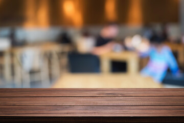 Empty wooden table space platform and blurred restaurant or coffee shop background for product display montage.