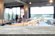 © qOppi - Empty wooden table space platform and blurred restaurant or coffee shop background for product display montage.