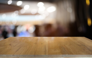 Empty dark wooden table in front of abstract blurred bokeh background of restaurant . can be used for display or montage your products.Mock up for space.