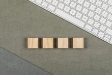 Business Concept With Keyboard, Wooden Cubes On Greenish Brown And Grey Background Flat Lay.