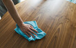 © stokkete - Woman cleaning the kitchen table with a cloth