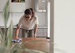 © stokkete - Woman cleaning the kitchen table with a cloth
