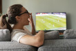 © stokkete - Woman watching football on TV