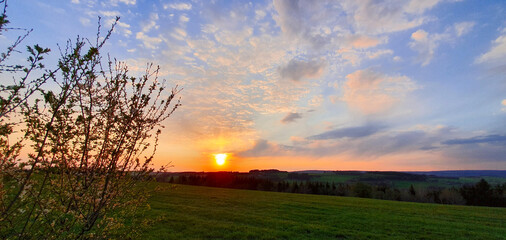 Wall Mural - Colorful dramatic sky with big clouds and sunset