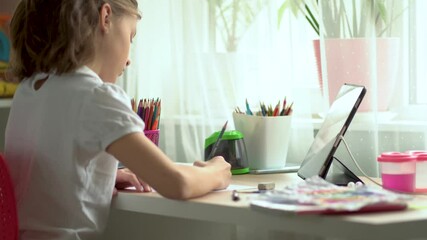 Wall Mural - Cute child use laptop for education, online study. Girl has homework at home schooling.