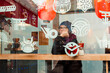 © Anna - a girl sitting in a japanese street food cafe behing the glass