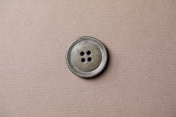 Poster -  antique button on the brown background