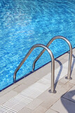 Fototapeta  - Railing to blue water pool