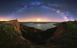 © Juan Lopez/ADDICTIVE STOCK - Amazing canyon with silhouette of unrecognizable person standing in cliff located near lake under colorful nigh sky with milky way on background