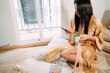 © Mario Pinta/ADDICTIVE STOCK - Gorgeous young lady in sleepwear sitting on floor with cup of aromatic tea and texting messages on mobile phone while spending weekend at home