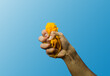 hand squeezing a fresh mango 