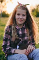 beautiful girl with a black rabbit and cabbage in her hands. little girl in a plaid shirt and two rabbits in her hands. beautiful blonde and a head of cabbage. childhood in the village