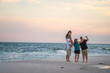 © Alejandro - united loving family taking a selfie all together in Pensacola beach, florida.