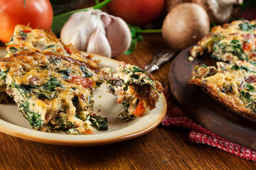 Wall Mural - Portion of frittata made of eggs, mushrooms and spinach