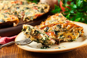 Wall Mural - Portion of frittata made of eggs, mushrooms and spinach