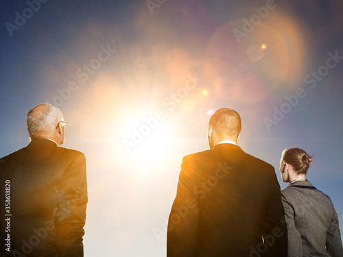 Fotografía Isolated photo of Rear view of three business people looking at sun