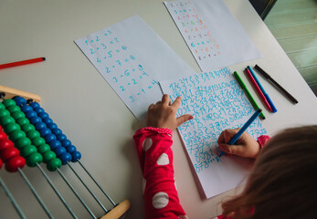 Wall Mural - little girl calculating numbers, kid doing homework, math for kids