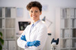 © pressmaster - Portrait of positive confident female laboratory researcher in goggles and white coat standing with crossed arms