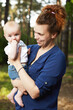 © Naz - Beautiful blonde mom with he baby in forest,summer time.