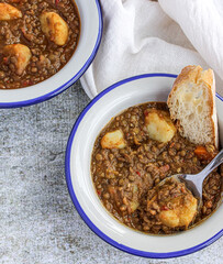 Wall Mural - Lentil soup with vegetables and potatoes. Typical Spanish lentil soup. 