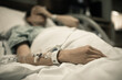 © kieferpix - Young woman patient lying at hospital bed feeling sad