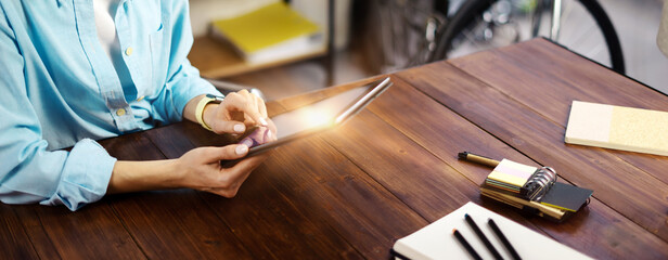 Woman pointing on digital tablet screen, chatting in social networks, meeting website, searching internet, sending sms, using text messenger or online banking. Close up photo