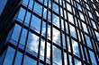 © Grand Warszawski - Facade texture of a glass mirrored office building. Fragment of the facade. Modern architecture of the office building.