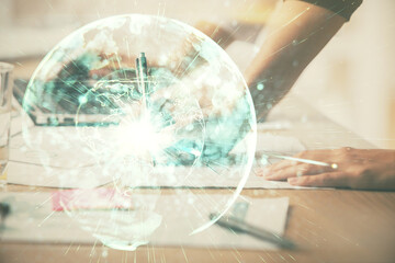 Double exposure of woman hands typing on computer and business theme hologram drawing. Success concept.