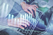 © peshkova - Double exposure of woman hands typing on computer and forex chart hologram drawing. Stock market invest concept.