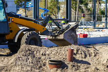 View Of The Construction Site With Construction Equipment, Front Loader In The Foreground