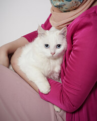 snowy is white cat in a woman's arms