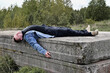 © Вячеслав Чичаев - The concept of devastation and sadness. Photo of a lying man in ruins outdoors