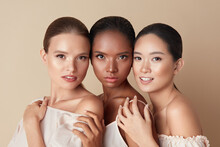 Beauty. Portrait Of Diversity Models. Mixed Race, Asian And Caucasian Girls Hugs Each Other And Looking At Camera. Different Ethnicity Women With Nude Makeup And Perfect Glowing Skin.