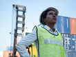 © StreetOnCamara - Foreman engineering africa women safety and white hat uniform is standing and look at warehouse container cargo shipping construction site project.female manager is working import export international