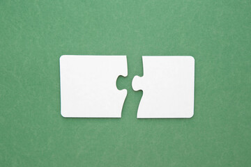 two empty puzzles for text on a green background 