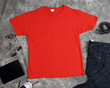 Front view of the blank red t-shirt template with gray abstract background. Plain t-shirts are taken from the top view accompanied by properties such as tablets, jeans, notes, belts etc.