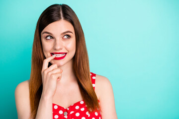 Wall Mural - Closeup photo of pretty funny lady bright lipstick tricky look side empty space have creative tricky idea biting finger wear red dotted retro dress singlet isolated teal color background