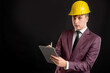 © Cipri Suciu  - Portrait of engineer architect builder with blond hair wears a yellow safety helmet dressed in burgundy jacket, white shirt and black tie