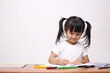 © airdone - Happy smart cute adorable little Asian baby girl drawing on desk, educational creativity childhood