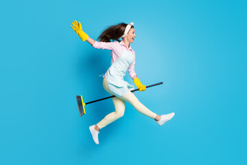 Sticker - Full length body size view of her she nice attractive cheerful cheery glad girl housekeeper cleaner jumping riding broom like horse fooling isolated on bright vivid shine vibrant blue color background