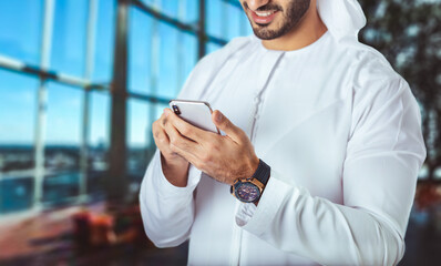 Businessman working on the smartphone.Close up of a business man using mobile smart phone, office background.