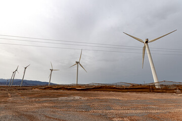 windmill park in the canaries with cloudy weather about to rain and abandoned greenhouses