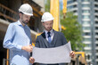© zinkevych - Foreman and building supervisor holding blueprint, studying it