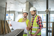 © zinkevych - Building worker showing blueprint to his colleague, both brainstorming over it