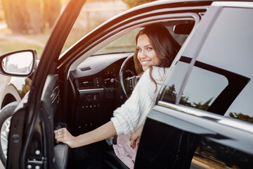 Pretty young woman sitting in the car 