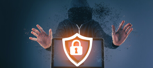 Hacker with laptop. Computer crime.