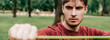 Panoramic orientation of handsome man working out with resistance band in park