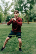 © LIGHTFIELD STUDIOS - Handsome sportsman working out with resistance band in park