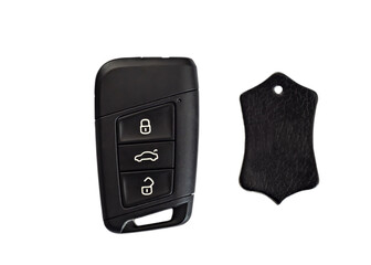 Car key with wireless remote and leather piece on white background